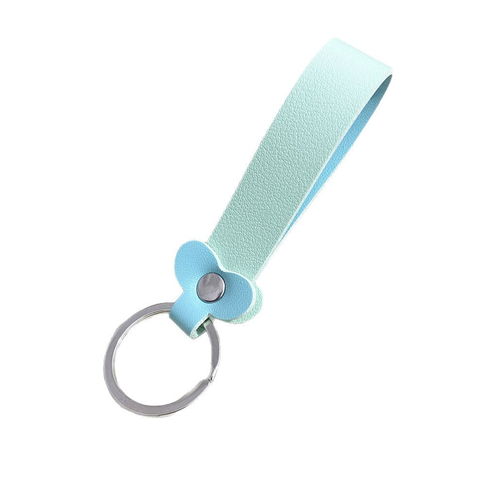 Close-up of vibrant floral design on a genuine leather key holder.