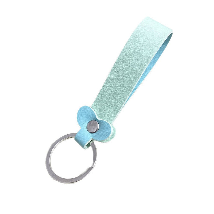 Close-up of vibrant floral design on a genuine leather key holder.