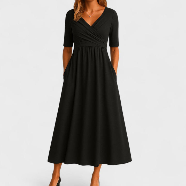 Chic grey V-neck midi dress with three-quarter sleeves & flattering fit. Ideal for versatile women's fashion.