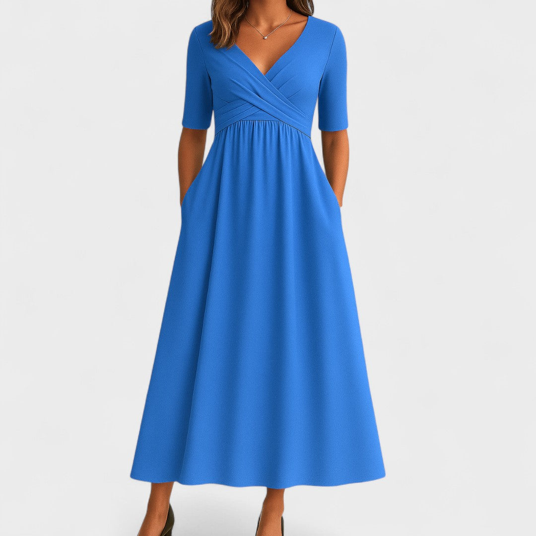 Stunning blue V-neck midi dress for women. Features a flattering fit & chic three-quarter sleeves.