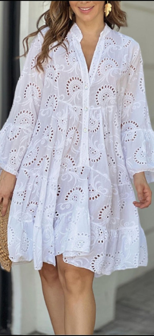 Women's bohemian tiered mini dress with elegant V-neckline, delicate embroidery, and stylish bell sleeves.