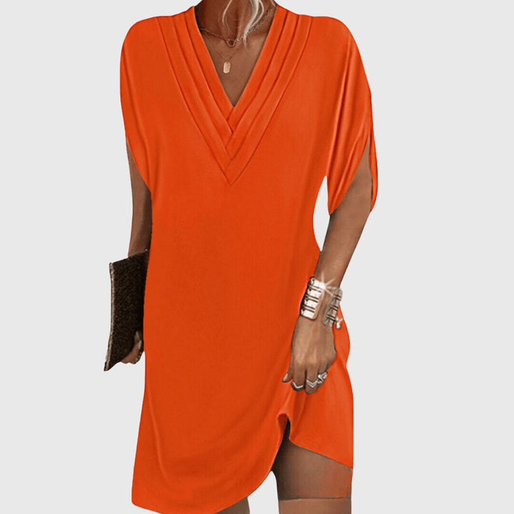 Sophisticated women's V-neck dress offering flattering tummy hiding. Chic, flowy, and comfortable for all occasions.