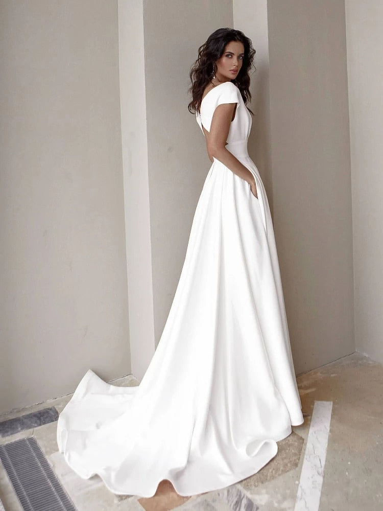 White floor-length women's formal gown with elegant V-neck and high slit. Perfect for evening occasions.