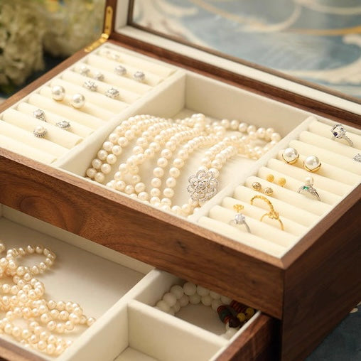 Stylish wooden jewelry box featuring rich walnut finish and plush velvet lining.