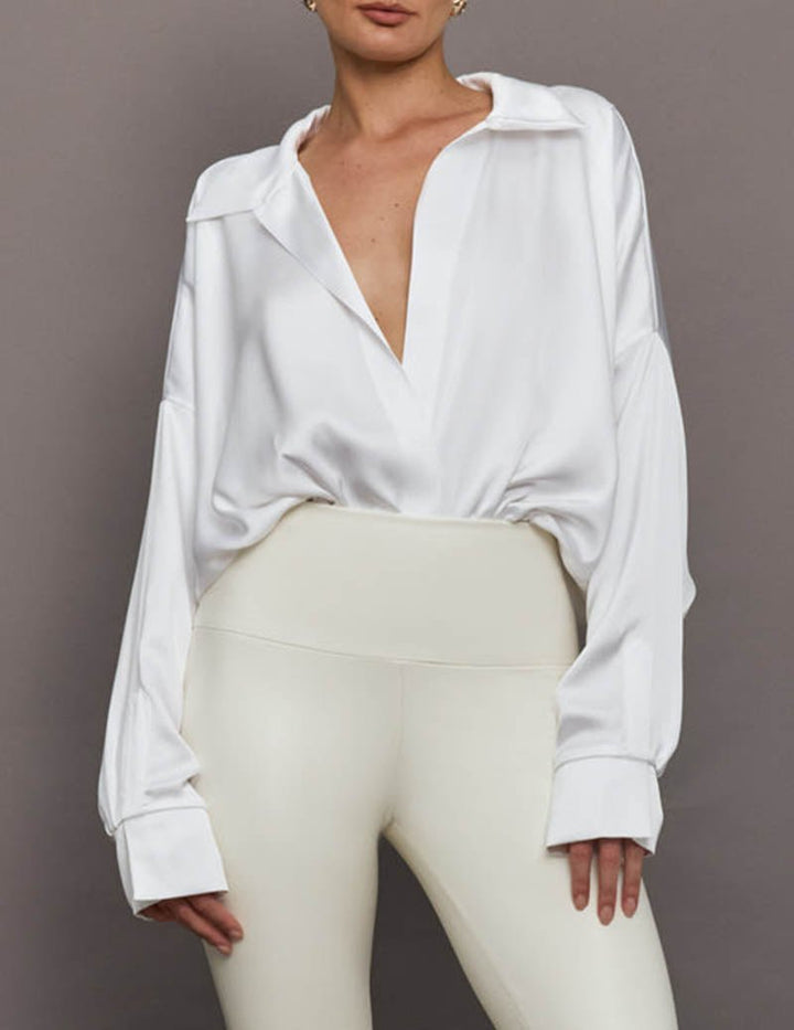 Professional women's collared bodysuit, draped front, long sleeves, suitable for work or smart casual.