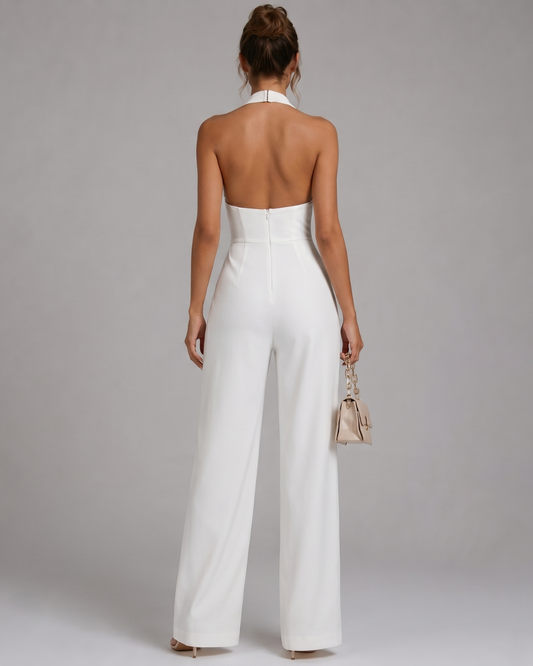 Sophisticated women's halter neck wide-leg jumpsuit. Versatile elegant occasion wear for formal events & summer parties.