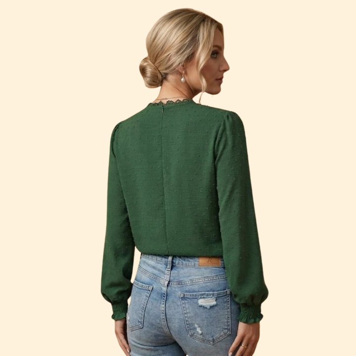 Stylish woman in an elegant lace embroidered blouse paired with jeans for a sophisticated yet casual look.