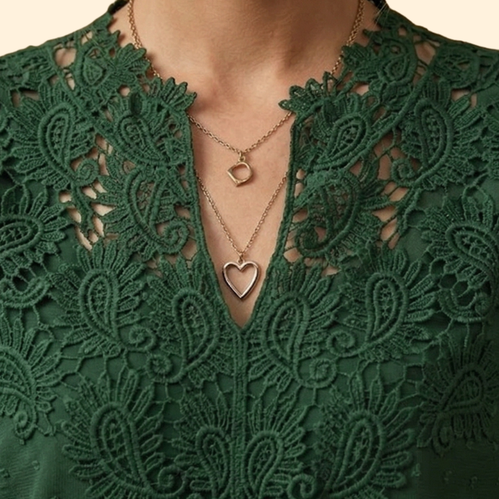 Intricately embroidered women's blouse with delicate lace trim, adding elegance to this versatile fashion top.