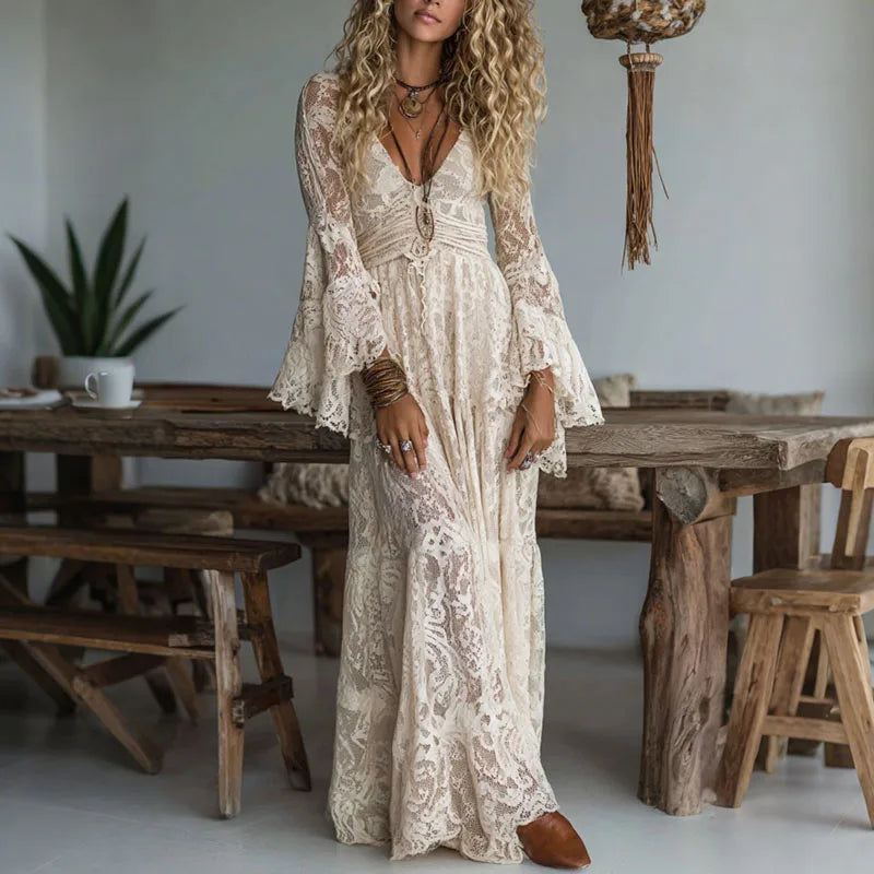 Elegant white maxi dress for women featuring intricate embroidery, a flattering V-neck, and stylish flare sleeves.