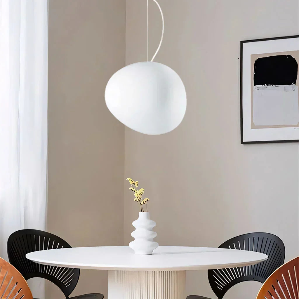 Stylish white pebble-shaped pendant light. Modern minimalist ceiling lamp for elegant interior design.