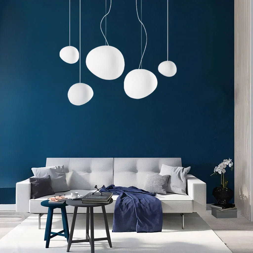 Modern white pebble pendant ceiling light. Elegant minimalist lamp for contemporary home interior design.