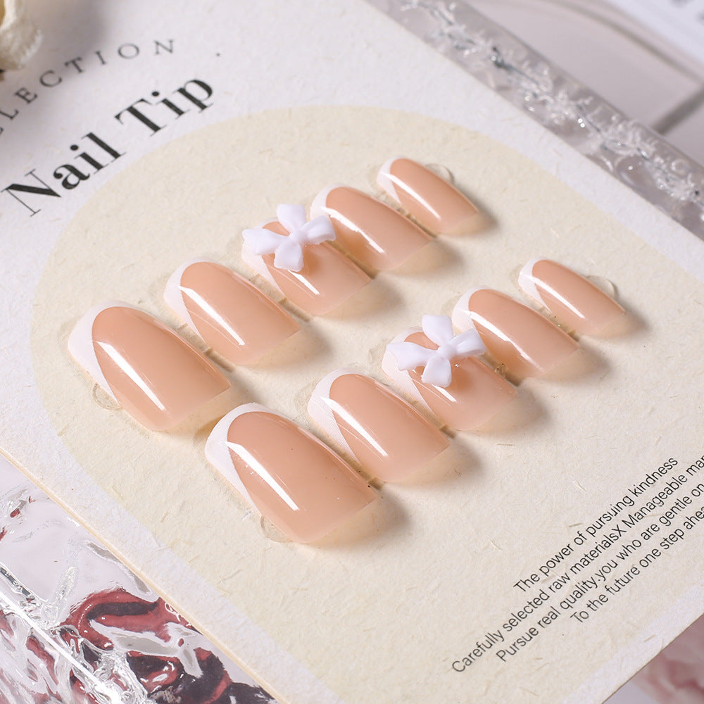Chic self-adhesive press-on nail tips for women. Elegant white fake nails with a stylish bow, perfect for quick beauty.