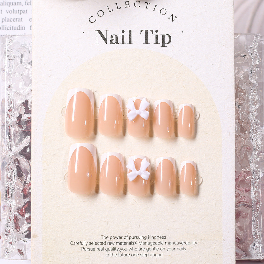 Women's elegant press-on nail tips set with white fake nails & bow accents. Self-adhesive for a beautiful, fast manicure.