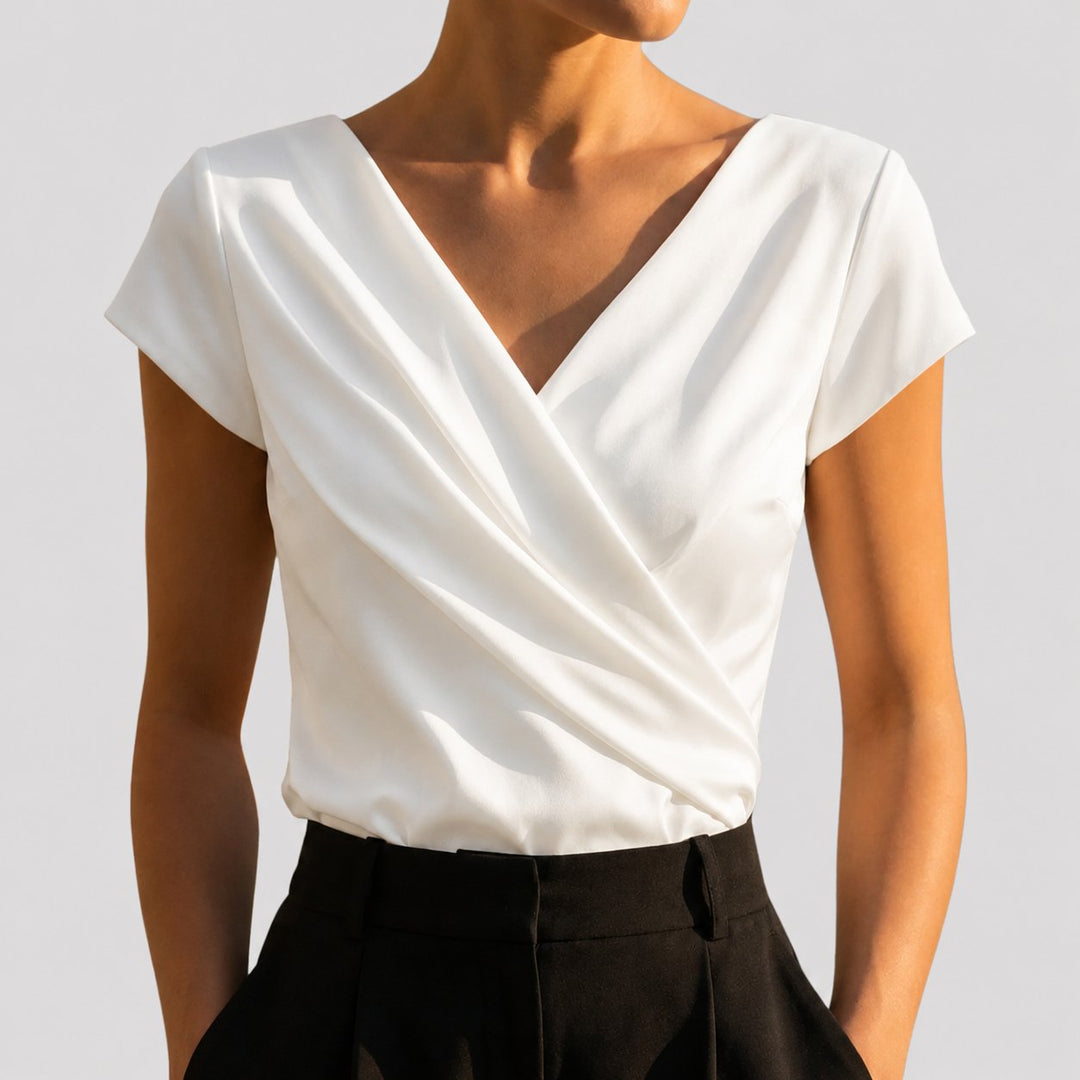 Elegant white women's draped wrap V-neck blouse with cap sleeves. Perfect for office or smart casual wear.