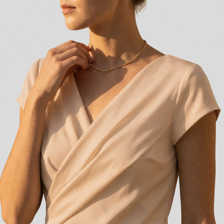 Stylish women's cap sleeve V-neck blouse in a draped wrap style. Ideal for office fashion or smart casual looks.