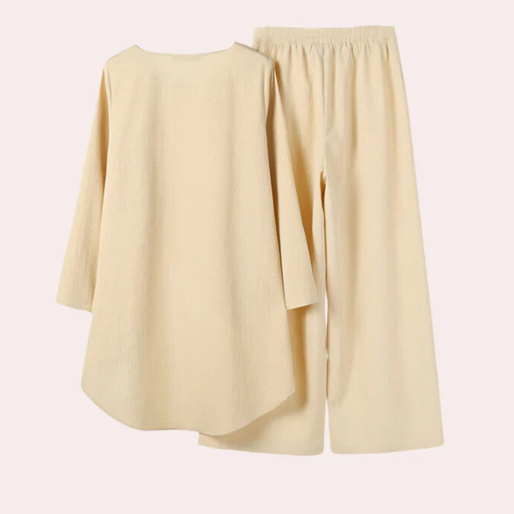 Modern blue women's two-piece blazer and trousers set. Elegant, tailored outfit for sophisticated business casual style.