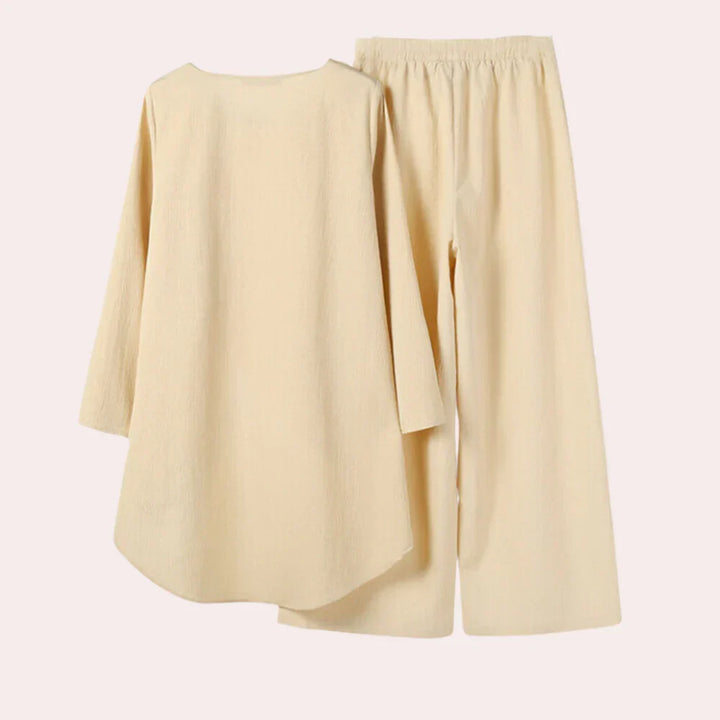 Modern blue women's two-piece blazer and trousers set. Elegant, tailored outfit for sophisticated business casual style.
