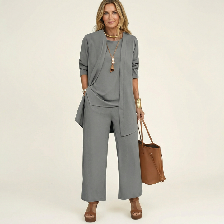 Fashionable women's 3-piece ensemble. Chic vest, soft blouse, and elegant wide-leg trousers for any occasion.