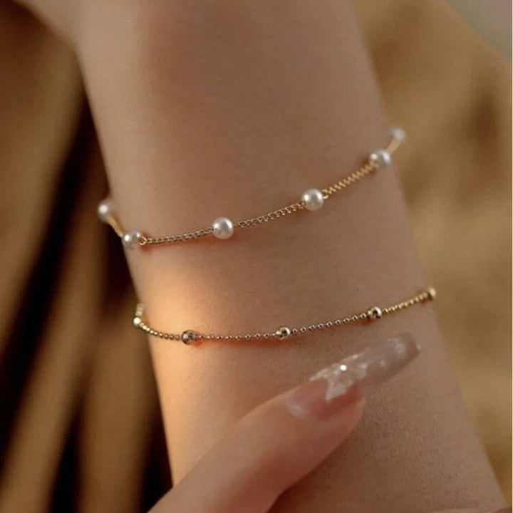 Elegant women's adjustable pearl charm bracelet, perfect fashion accessory & gift for her.
