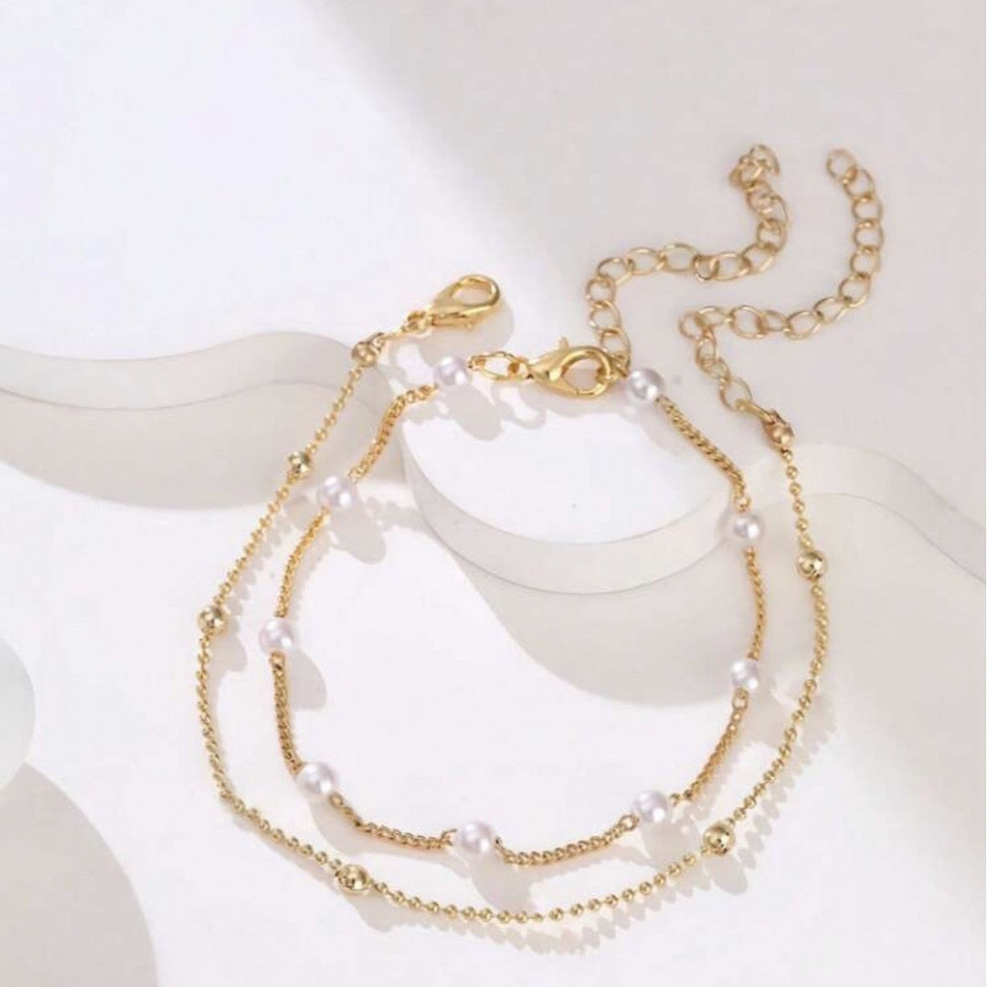 Beautiful pearl bracelet featuring delicate charms, an adjustable & elegant accessory for women.