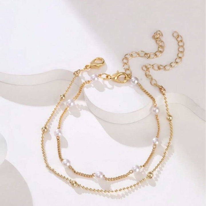 Beautiful pearl bracelet featuring delicate charms, an adjustable & elegant accessory for women.
