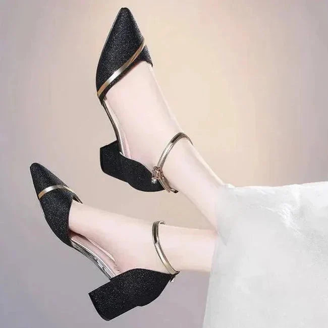 Formal women's pumps featuring a comfortable block heel and secure ankle strap, designed with a classic pointed toe.