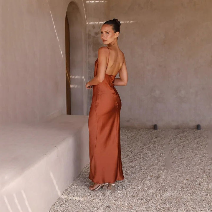 Wedding guest attire: Elegant backless maxi dress for women, features a flattering high slit.