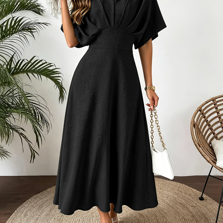 Close-up of the ruffle V-neck and elegant batwing sleeve detail on a women's flowing midi dress.