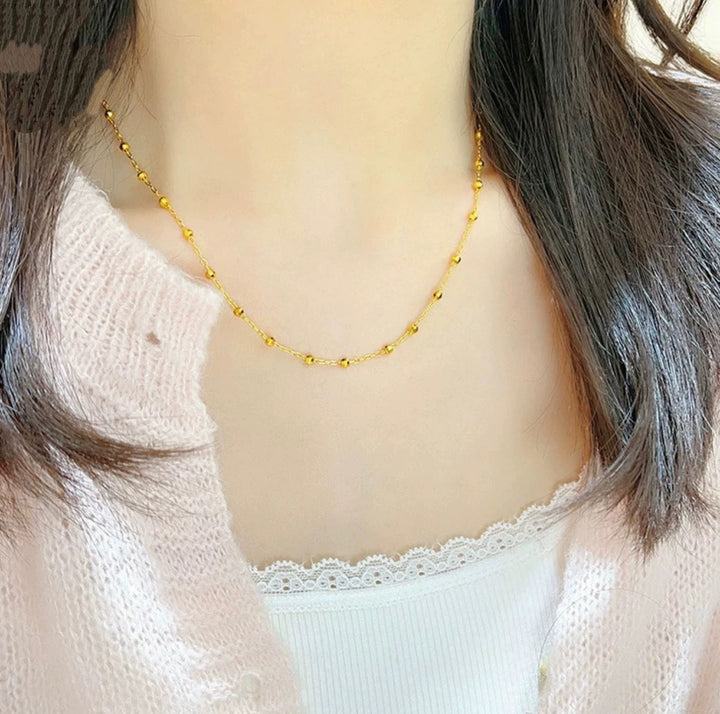 Elegant women's beaded chain necklace with delicate gold finish, adjustable length. Perfect fashion accessory.