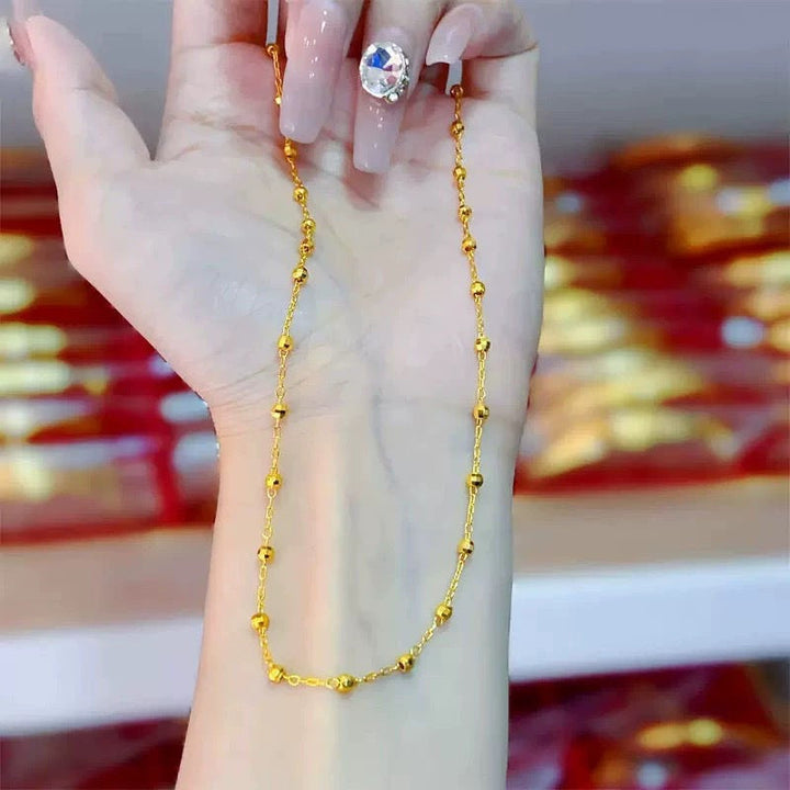 Adjustable women's beaded chain necklace in gold, a versatile and elegant fashion accessory for any outfit.