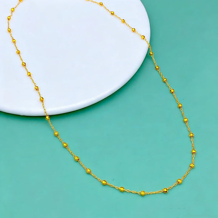 Dainty women's beaded gold chain necklace, an elegant and adjustable piece of fashion jewelry for women.