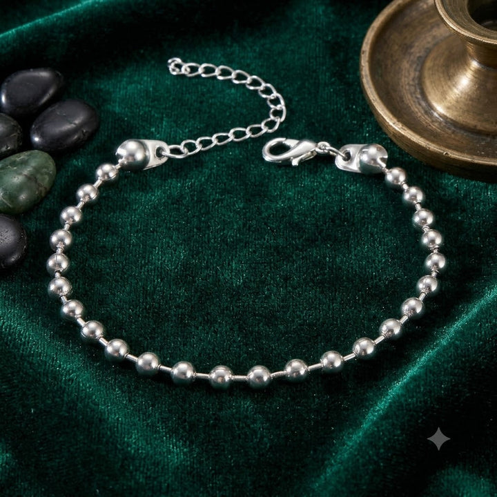 Beautiful women's adjustable beaded bracelet with sparkling gold and white charms, an elegant fashion statement.