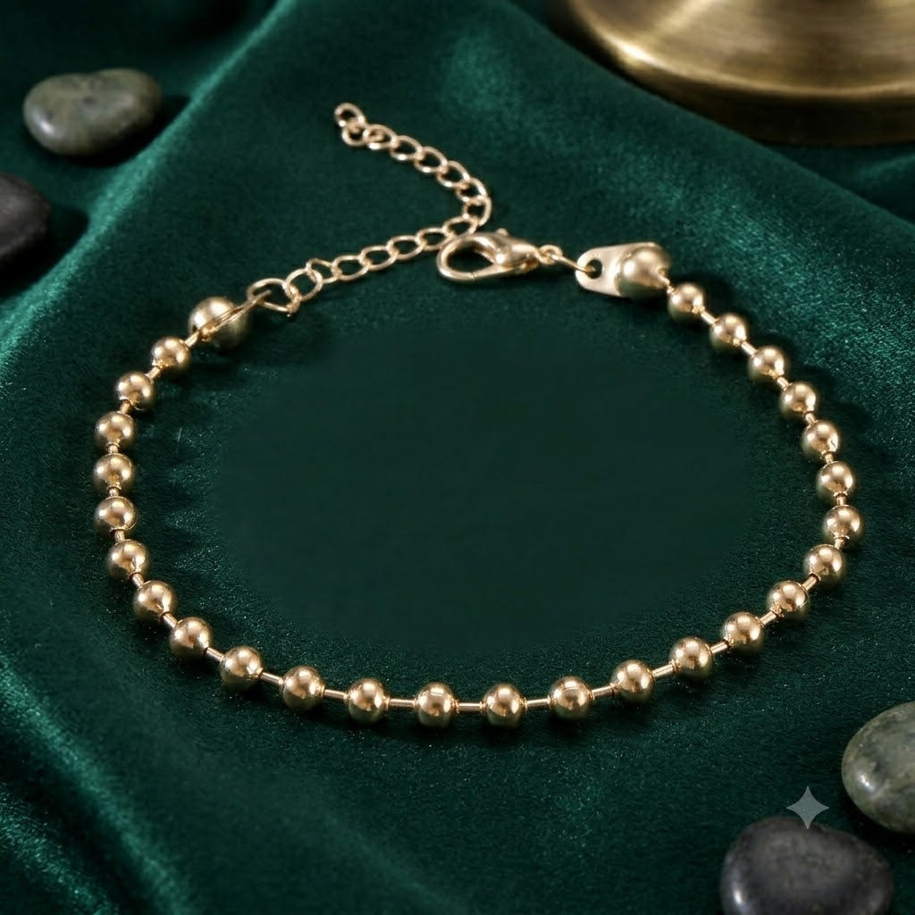 Dainty gold and white beaded charm bracelet for women, a charming and elegant adjustable jewelry piece.
