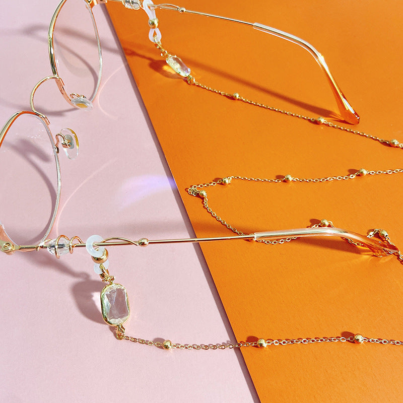 Sparkling crystal & pearl beaded chain. Stylish holder for women's eyeglasses or face masks. Elegant accessory.