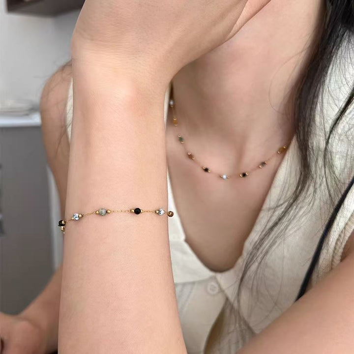 Elegant women's beaded jewelry set featuring a necklace, bracelet, and anklet. Perfect fashion accessory.