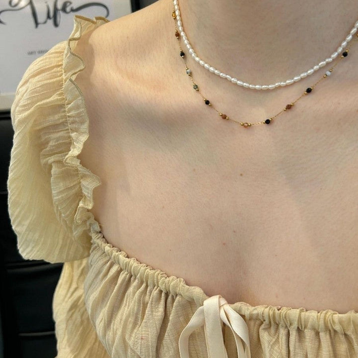 Close-up of elegant women's beaded necklace and bracelet, perfect for fashion and special occasions.