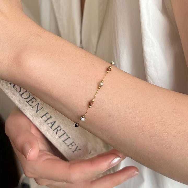 Fashionable women's beaded accessory set with an elegant necklace, bracelet, and delicate anklet.