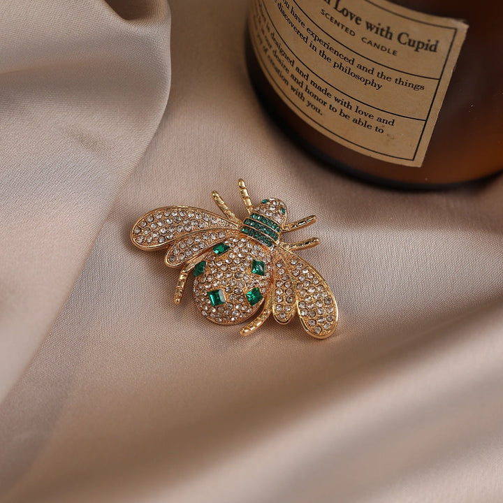 Elegant women's bee brooch with sparkling rhinestones & gold finish. Nature-inspired fashion pin, perfect gift for her.
