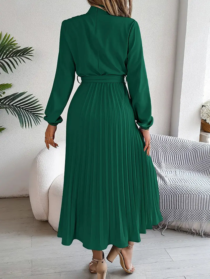 Flowing pleated midi dress with long sleeves and elegant belt, great for women's formal or work wear.