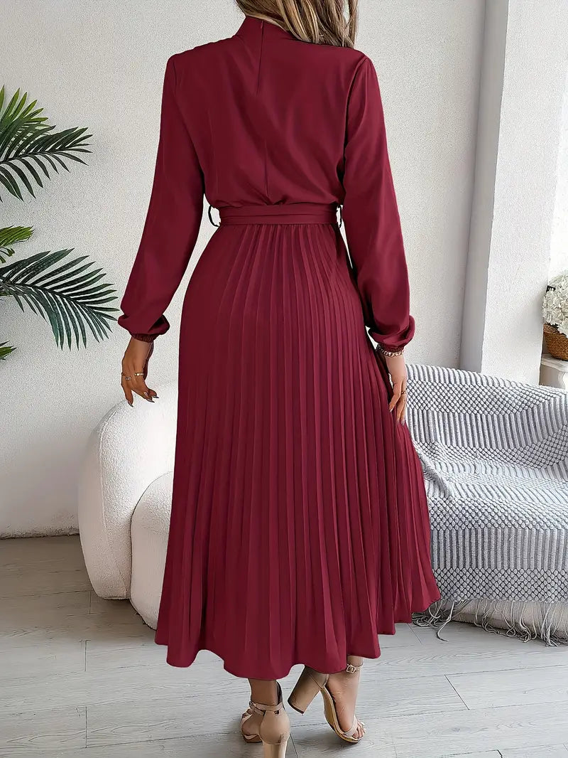 A-line pleated midi dress with a cinched belt and long sleeves, offering an elegant women's silhouette.
