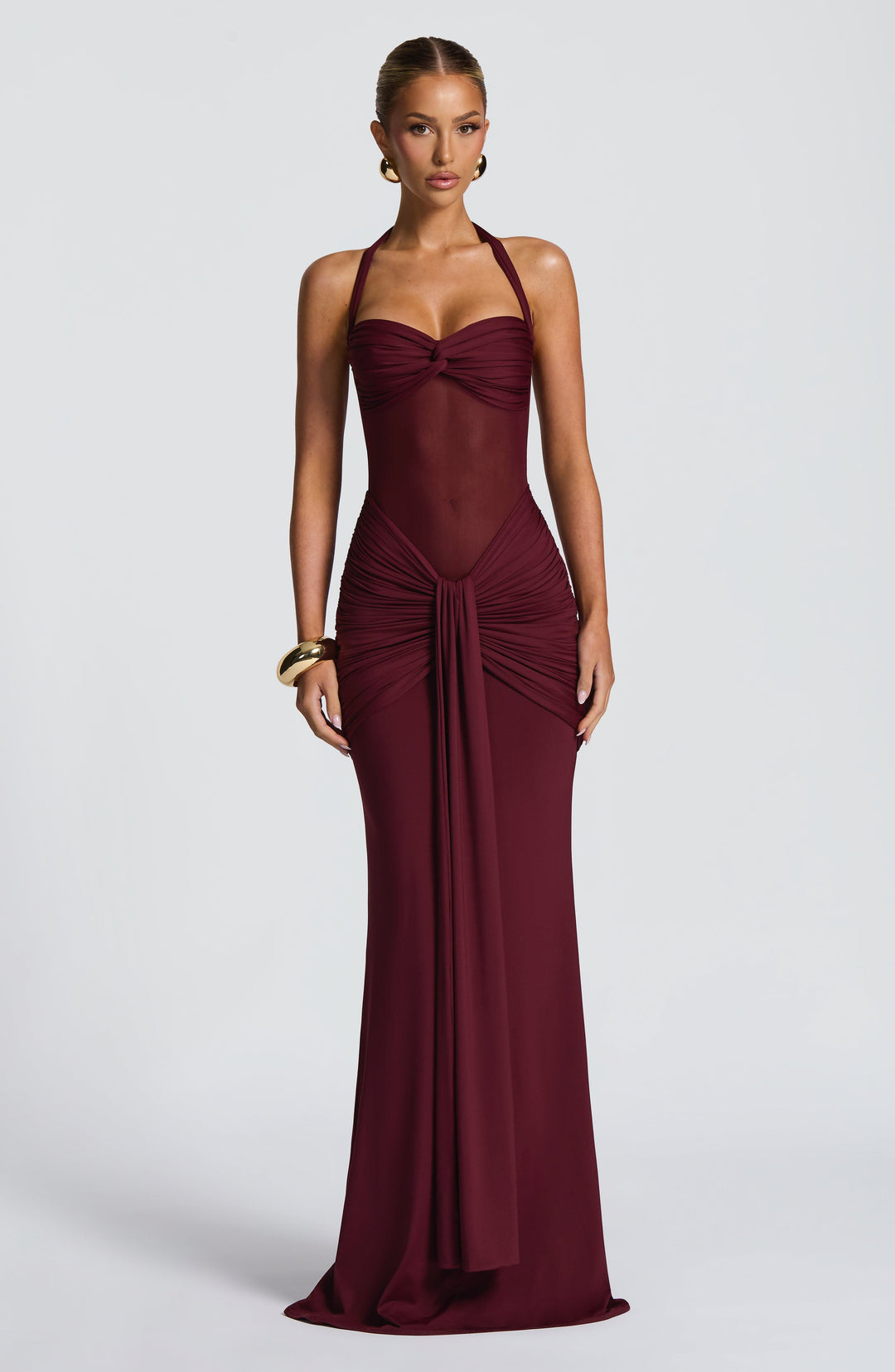 Black halter neck maxi dress for women, featuring a sophisticated ruched waist and sheer mesh detail. Ideal formal wear.