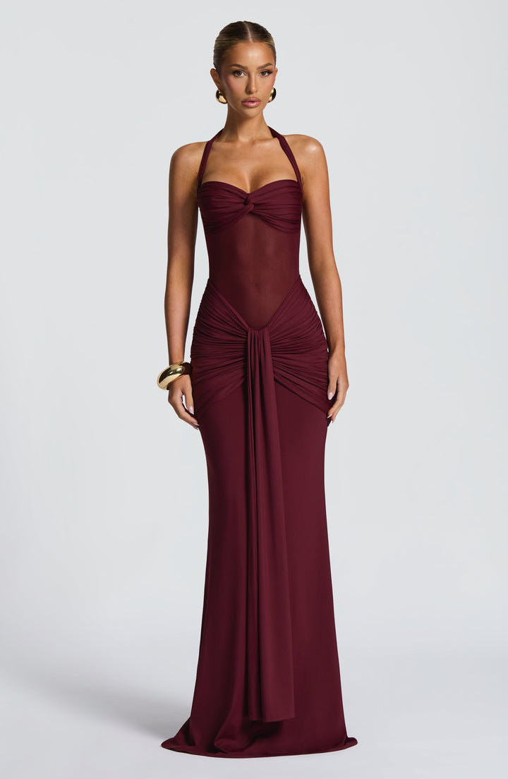 Black halter neck maxi dress for women, featuring a sophisticated ruched waist and sheer mesh detail. Ideal formal wear.
