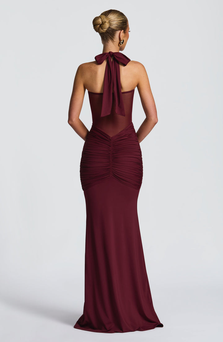 Stunning red halter neck maxi dress with ruched waist, elegant mesh detail. Perfect party or formal evening wear.