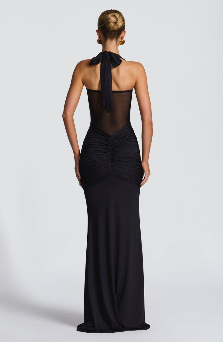 Women's elegant maxi halter dress showcasing a ruched waist and stylish mesh detail, perfect for formal events.