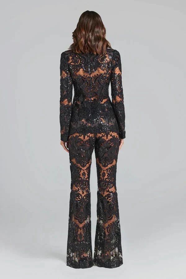 Fashionable women's two-piece lace outfit. Features a stylish sheer blazer and elegant flared trousers.