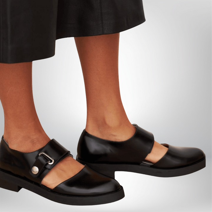 Classic black low heel strap shoes for women, featuring a stylish buckle and comfortable design for elegant formal wear.