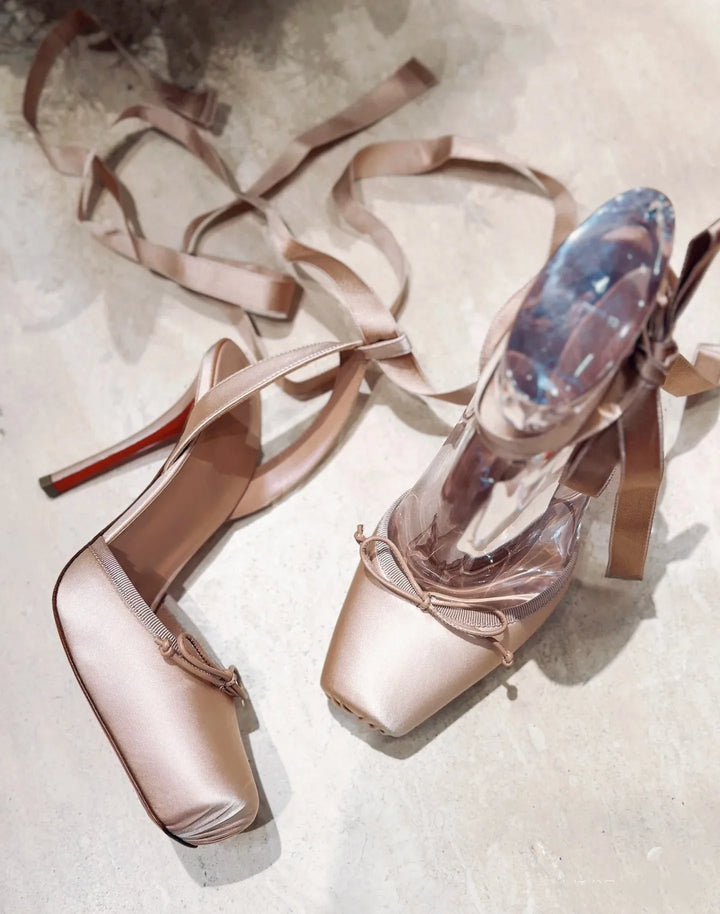Side view of women's high-heel platform dress shoes, sleek design & secure ankle strap for elegant occasions.