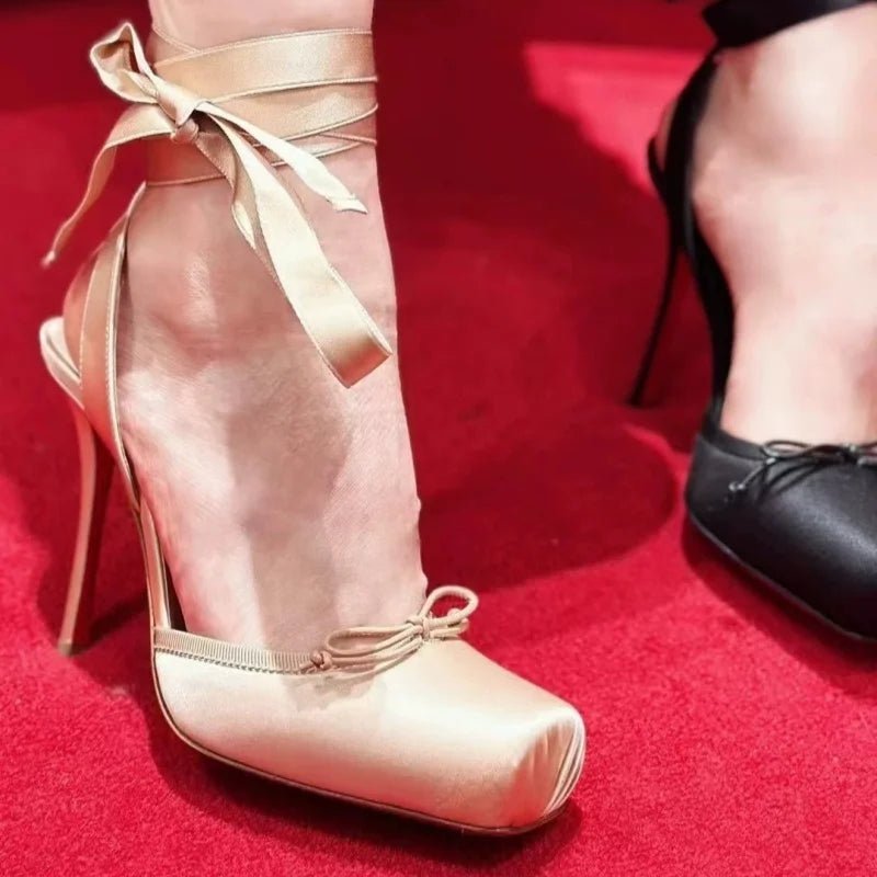 Stylish women's foot in elegant platform ankle strap court shoes, ready for a party or formal event.