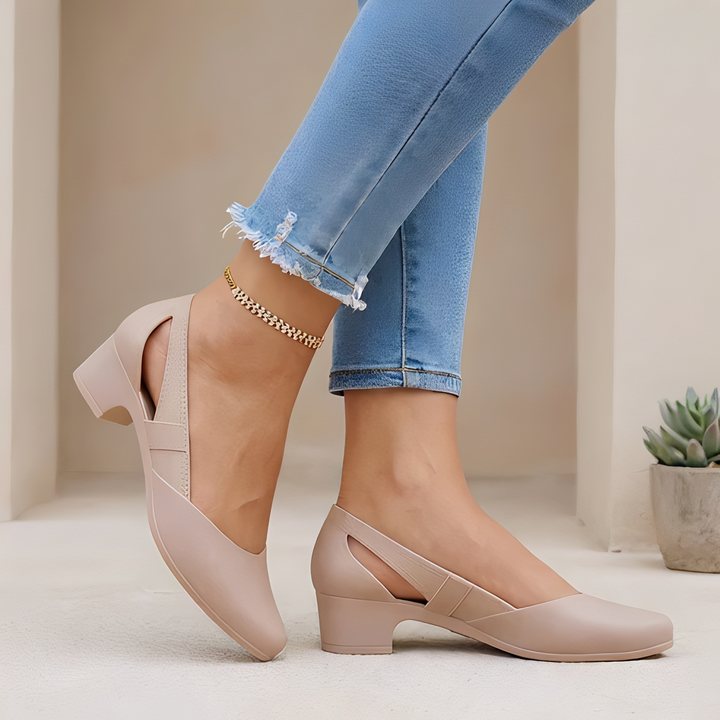 Elegant women's block heel pumps with chic cutout details, perfect for office or evening wear. Comfortable pointed toe slip-ons.