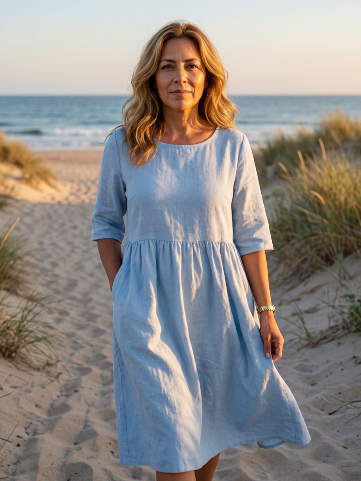 Elegant women's blue flowy midi dress with half sleeves & round neck, perfect for summer comfort.